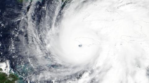 A handout satellite image made available by NASA's Worldview application, pshows Hurricane Melissa approaching Jamaica, 28 October 2025 as a category five storm.