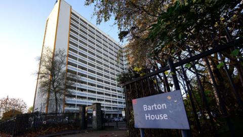 The Barton House tower block from street view, with the Barton House sign outside