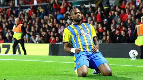 Cyle Larin slides on his knees as he celebrates scoring for Southampton