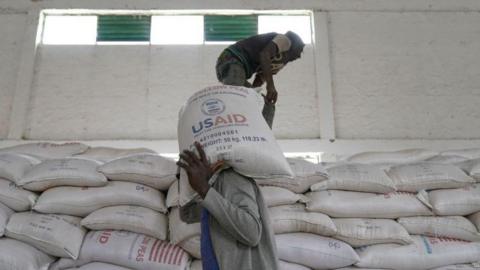 Aid workers move bags of lentils provided by USAID in Mekele, capital city of the Tigray region of Ethiopia, in 2021.