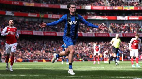 Alex Scott celebrates