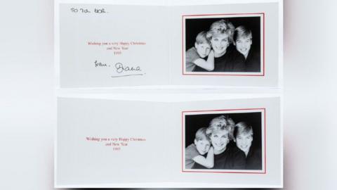 Two Christmas cards from Princess Diana showing a black and white photo of her with a young William and Harry