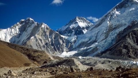  The Himalayas loom large in the background with the peaks covered in snow