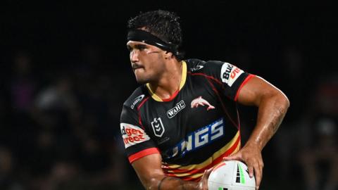 Mason Teague, with black strapping around his forehead, playing for Dolphins in the NRL 
