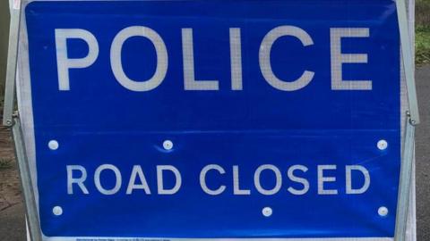 Sign reading: 'POLICE. ROAD CLOSED'