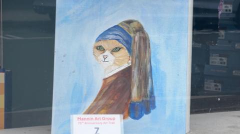 A painting of a cat on a canvas in the style of Johannes Vermeer's 'Girl With a Pearl Earing'