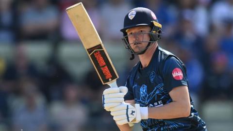 Aneurin Donald watches the ball after playing a shot for Derbyshire