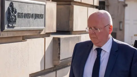 peter murrell walking into court