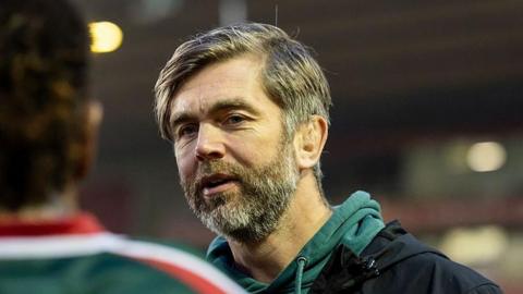 Leicester Tigers head coach Geoff Parling. He is wearing a green jumper and has a slight smile on his face. 