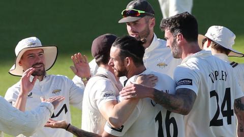 Surrey celebrate Jordan Clark's wicket against Hampshire