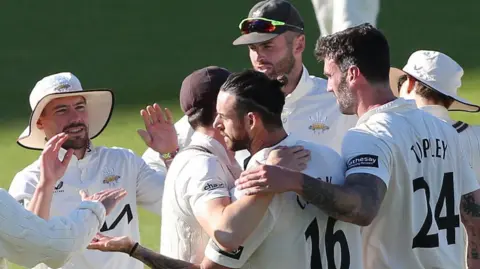 Surrey celebrate Jordan Clark's wicket against Hampshire