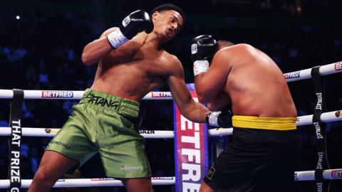 Leo Atang (left) hits Milen Paunov with a bodyshot