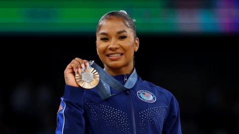 Jordan Chiles holding a bronze medal