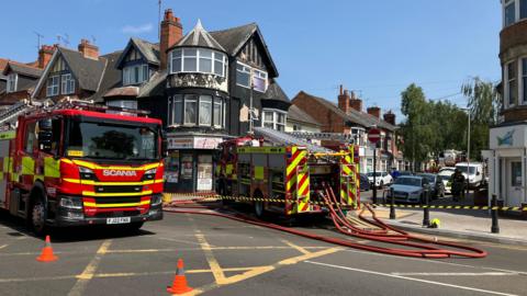 A side street cordoned off with emergency services working on the scene of a fire