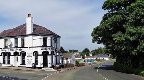 The road which curves around, you can see the pub which reads Ginger Hall.