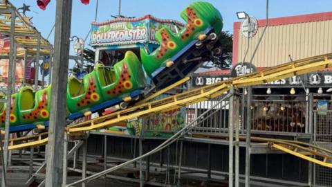 A rollercoaster flipped up off its tracks.