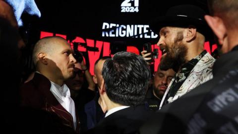 Oleksandr Usyk stares at Tyson Fury during a face-off