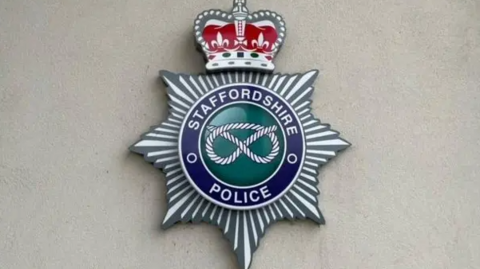 The photo shows the badge insignia for Staffordshire Police