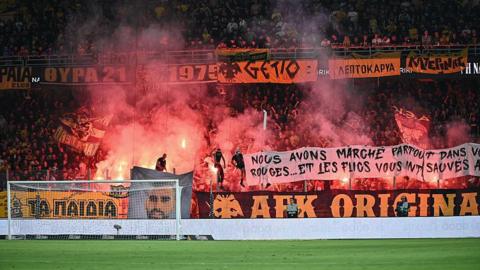 AEK supporters with pyrotechnics ahead of the Conference League qualifying match against Anderlecht
