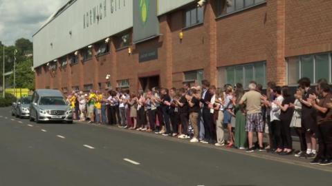 Fans outside Carrow Road applauding the funeral cortege