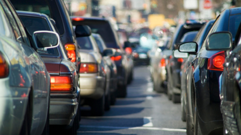 Row of cars bumper to bumper on road