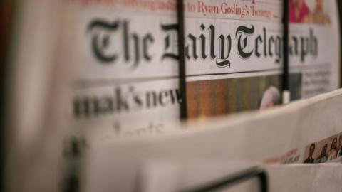 Daily Telegraph paper on a stand
