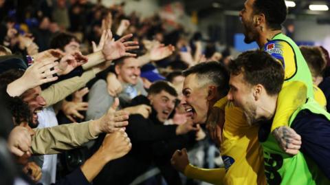 Dagenham & Redbridge players and fans celebrate