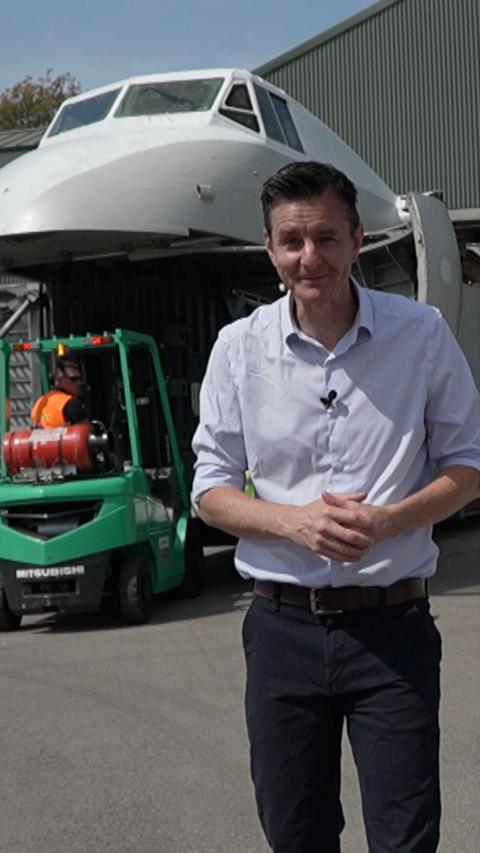A man standing in front of a large aircraft