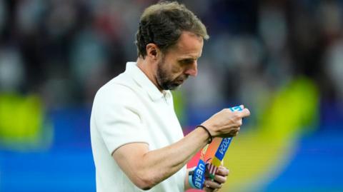 Gareth Southgate holds his Euro 2024 runners-up medal