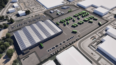 A CGI image of how the new bus depot could look. Large industrial buildings can be seen as well as a fleet of green buses in a car park.