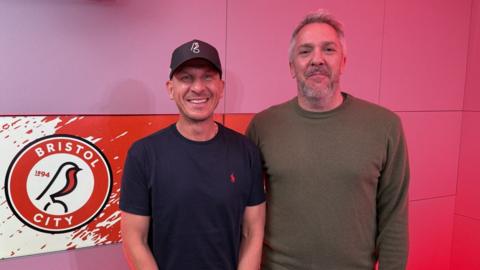 Gerhard Struber and Ed Hadwin stood in a red studio
