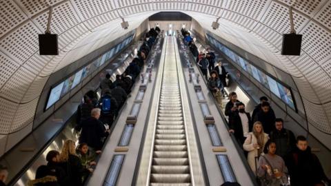 Commuters on escalators at Elizabeth line station