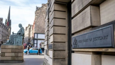 The exterior of the High Court in Edinburgh. A sign on the wall says High Court of Justiciary
