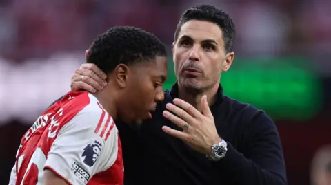 Myles Lewis-Skelly and Mikel Arteta