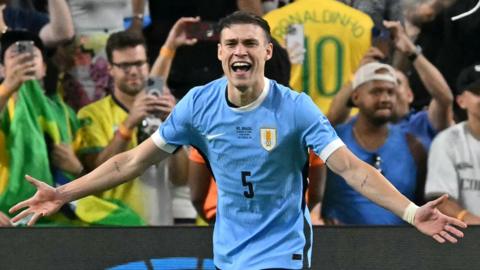 Uruguay's Manuel Ugarte celebrates after scoring in a penalty shoot-out to win Copa America quarter-final against Brazil