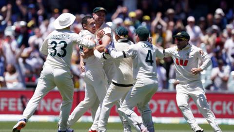 Australia's Scott Boland (left) celebrates with teammates after taking the wicket of England’s Josh Tongue (not pictured) to win the match 
