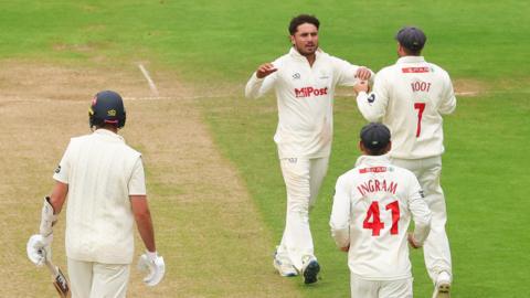 Kiran Carlson and Billy Root celebrate as they combine to dismiss Matt Quinn