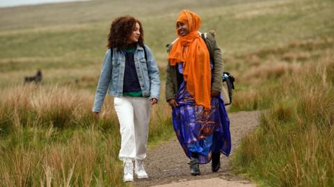 Two people walking in the countryside