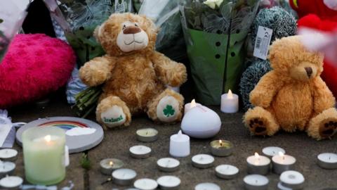 Stuffed animals and flowers are seen following a vigil for the victims of the knife attack in Southport
