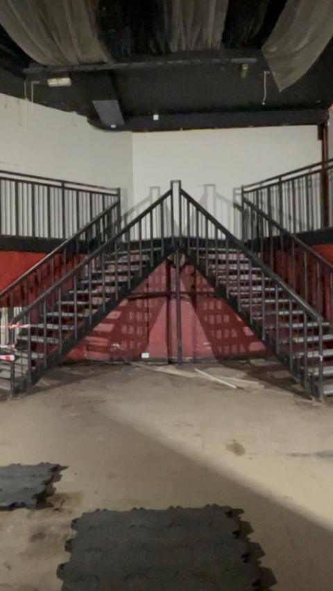 A set of triangular stairs in a defunct nightclub.