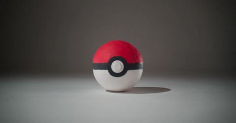 a plasticine version of the famous pokeball done in a classic aardman animations style on a plain background