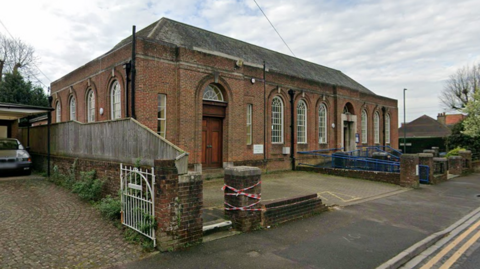 Google Streetview image of a red brick building, which is Charminster Library