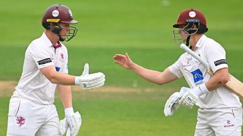 Somerset batters James Rew (left) and Tom Abell celebrate their fourth-wicket partnership against Nottinghamshire