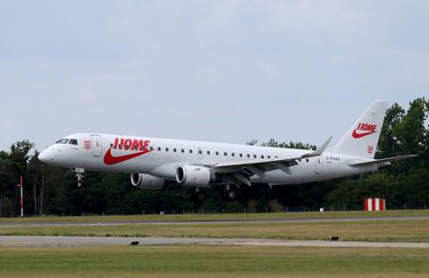 Plane touching down with England logo and word Home in red letters 