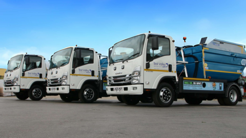 Three lorries with food waste collection facilities on the back of them.