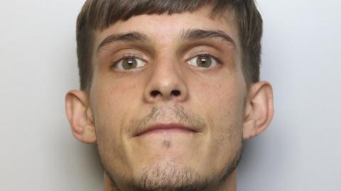 Jordan Dutton, who has short brown hair, brown eyes and a short goatee beard.