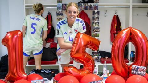 Sophie Ingle with numbered balloons spelling out 150 in the Wales dressing room in Albania 