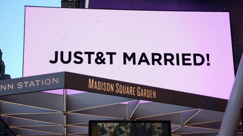 A screen displays a message referencing singer Taylor Swift and National Football League (NFL) player Travis Kelce outside Madison Square Garden