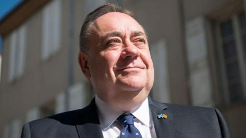 Alex Salmond standing in street