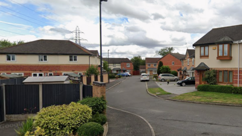 A long residential street with semi-detached houses